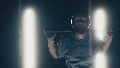 Caucasian-professional-baseball-player-batter-posing-against-dark-background.-4K-UHD-60-FPS-SLOW-MOTION